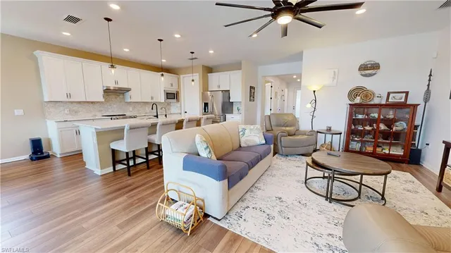a living room with furniture and kitchen view