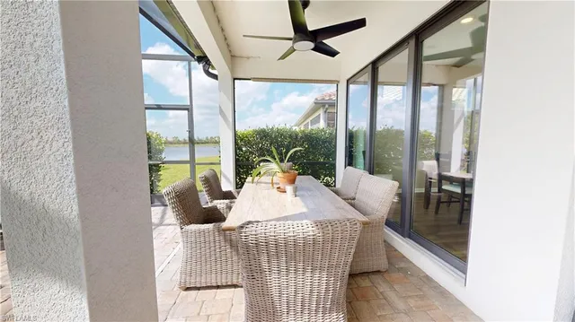 a living room with couch and a floor to ceiling window