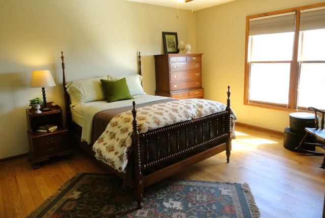 496 Lewis Road Geneva, IL 60134 - Photo 11 of 18 a bedroom with a bed and wooden floor