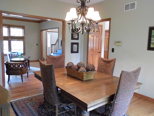496 Lewis Road Geneva, IL 60134 - Photo 4 of 18 a view of a dining room with furniture and chandelier