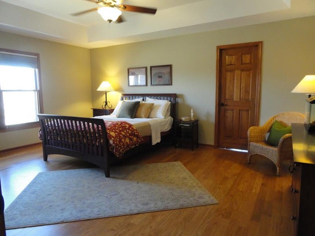 496 Lewis Road Geneva, IL 60134 - Photo 8 of 18 a bed room with a bed and a chair