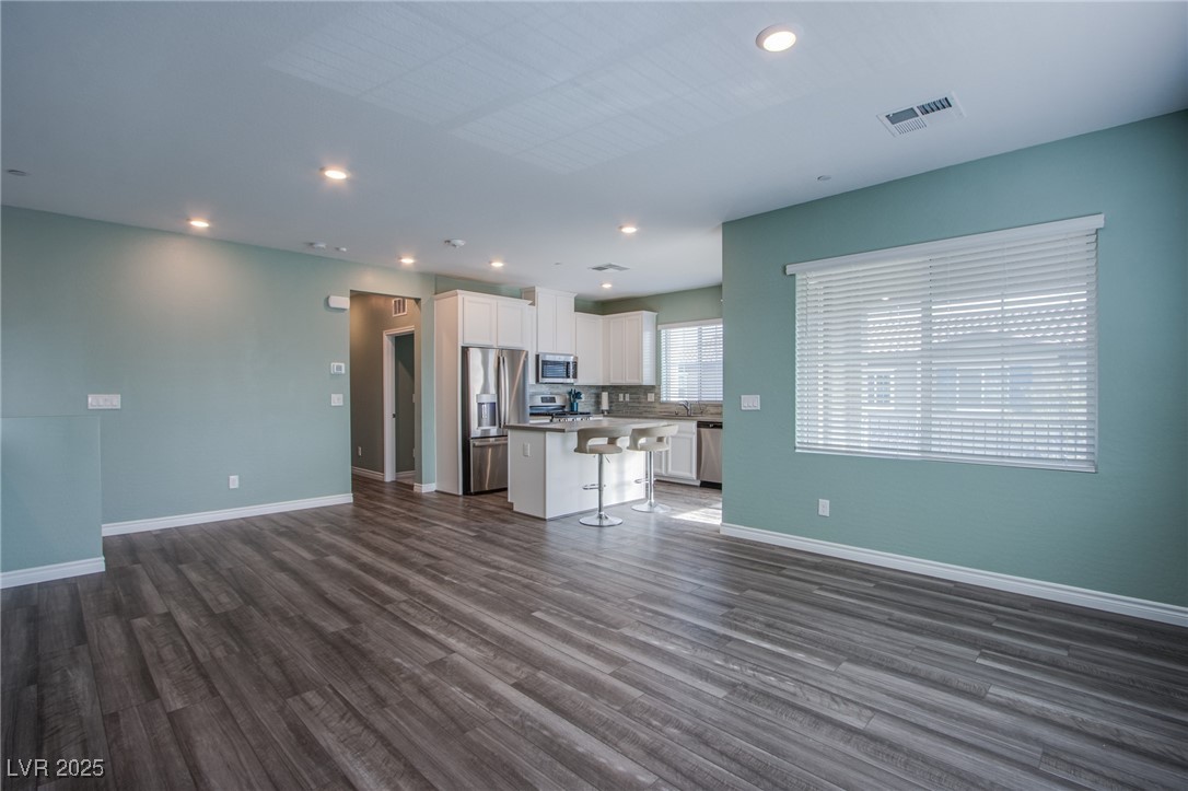 7336 North Decatur Boulevard, Unit 1 North Las Vegas, NV 89084 - Photo 5 of 39 Very large living room off the stair entry from the garage, and the front door below.,
