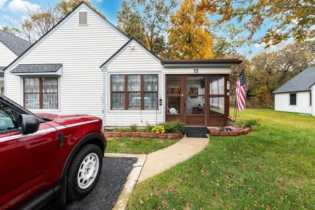 a front view of a house with a garden and yard