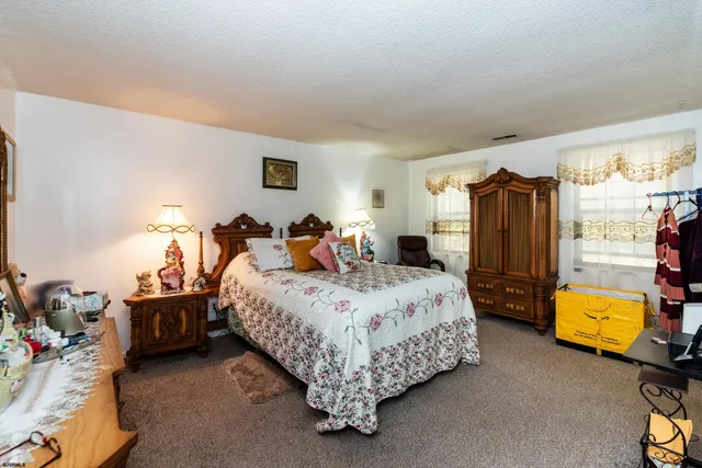 a bed room with a bed and a chair