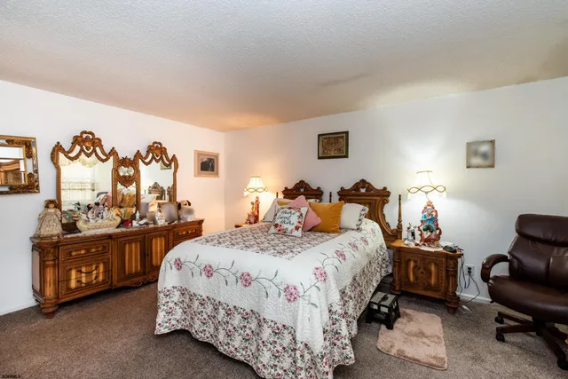 a bed room with a bed and a chair