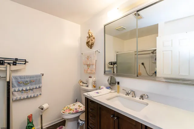 a bathroom with a double vanity sink mirror and toilet