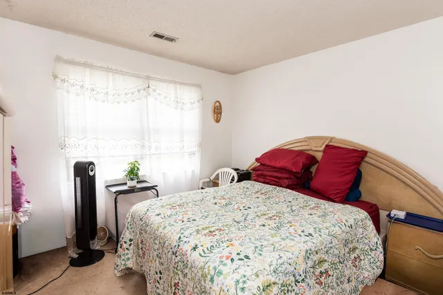 a bedroom with a large bed and a window