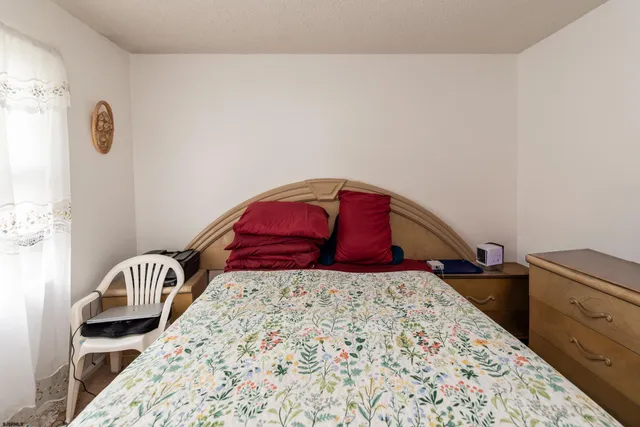 a bedroom with a bed and dresser