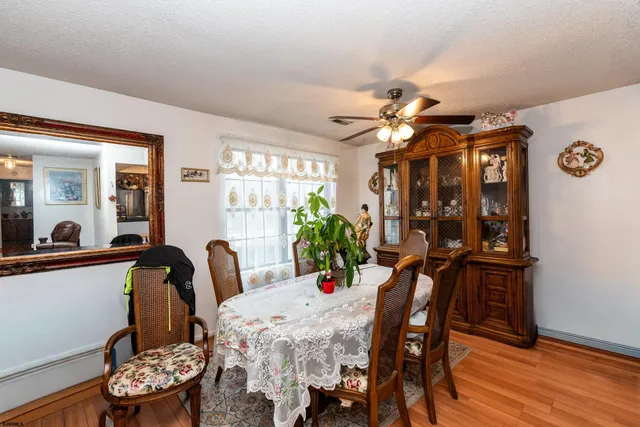 a view of a dining room with furniture and chandelier