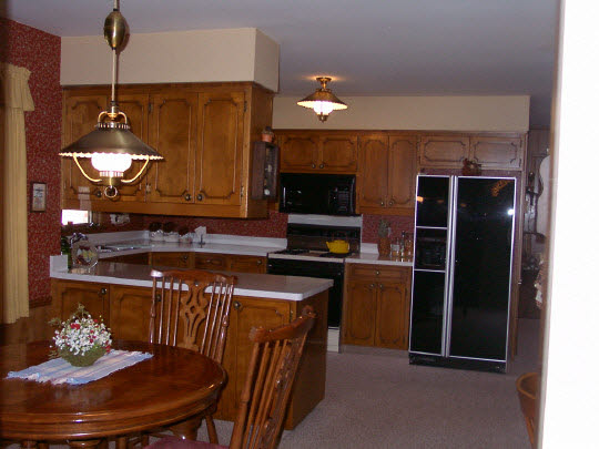 3915 Landstrom Road Rockford, IL 61107 - Photo 5 of 6 a kitchen with a stove and a refrigerator