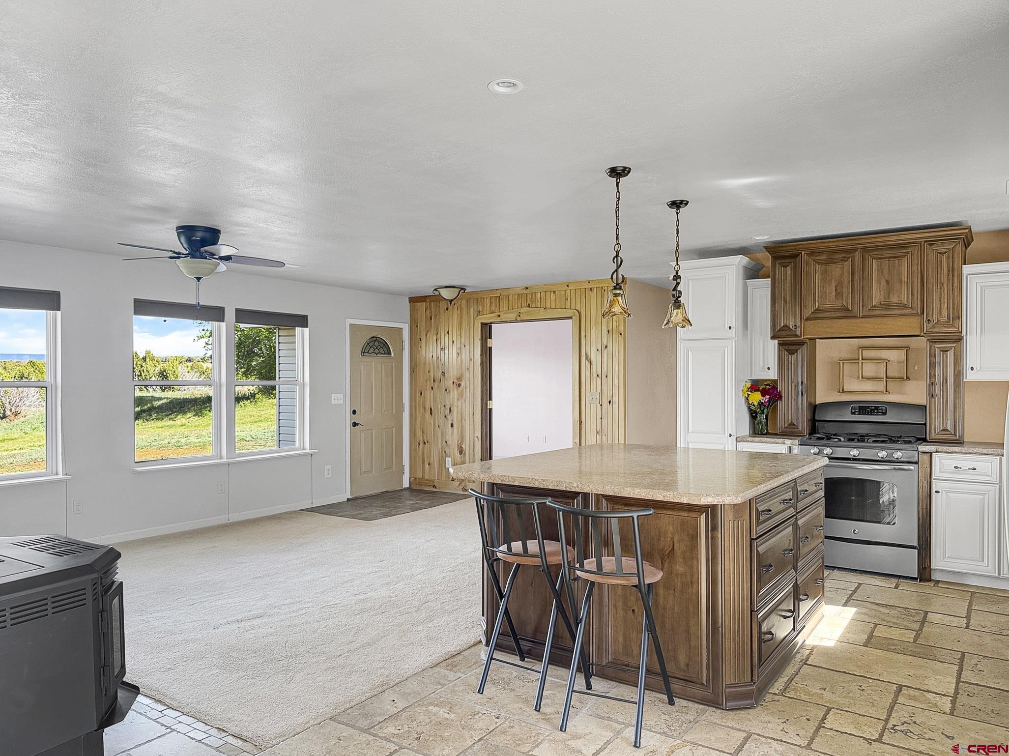 32310 B50 Road Crawford, CO 81415 - Photo 10 of 45 a kitchen that has a kitchen island wooden cabinets and stainless steel appliances