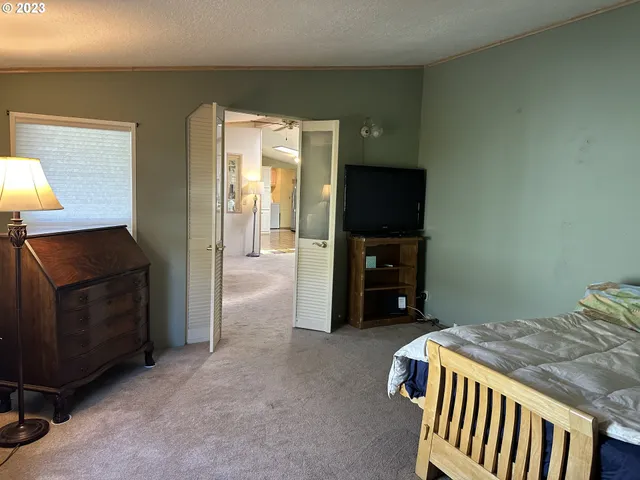 a bedroom with a bed and a television