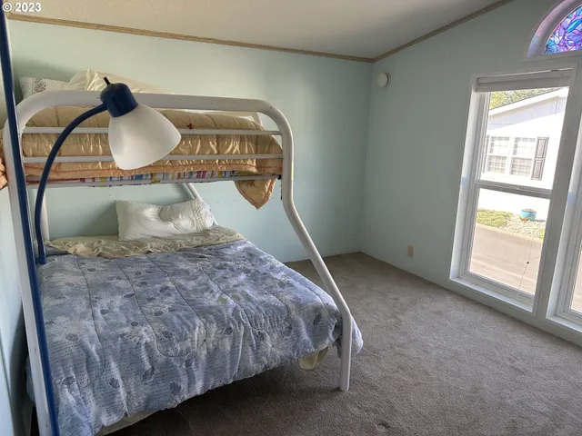 a bed sitting in a room next to a window