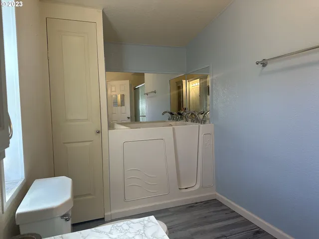 a bathroom with a sink a toilet and mirror