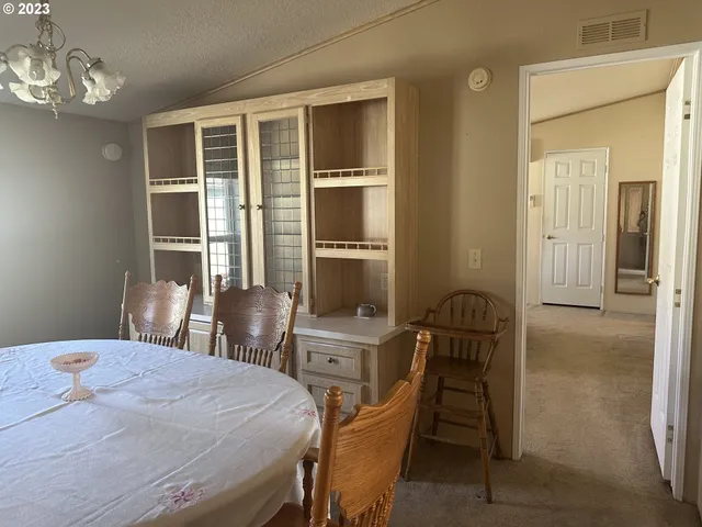 a bedroom with a bed and a table with chair