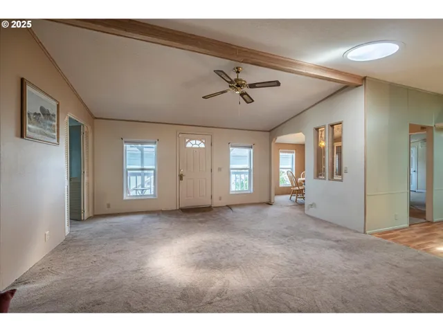 a kitchen with granite countertop a stove cabinets and wooden floor