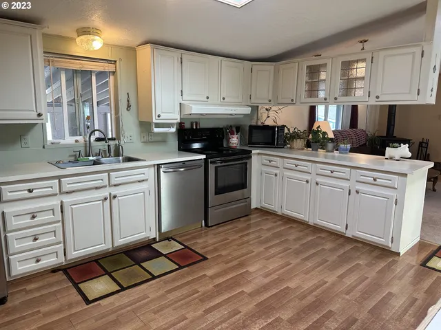 a kitchen with a sink stove and cabinets