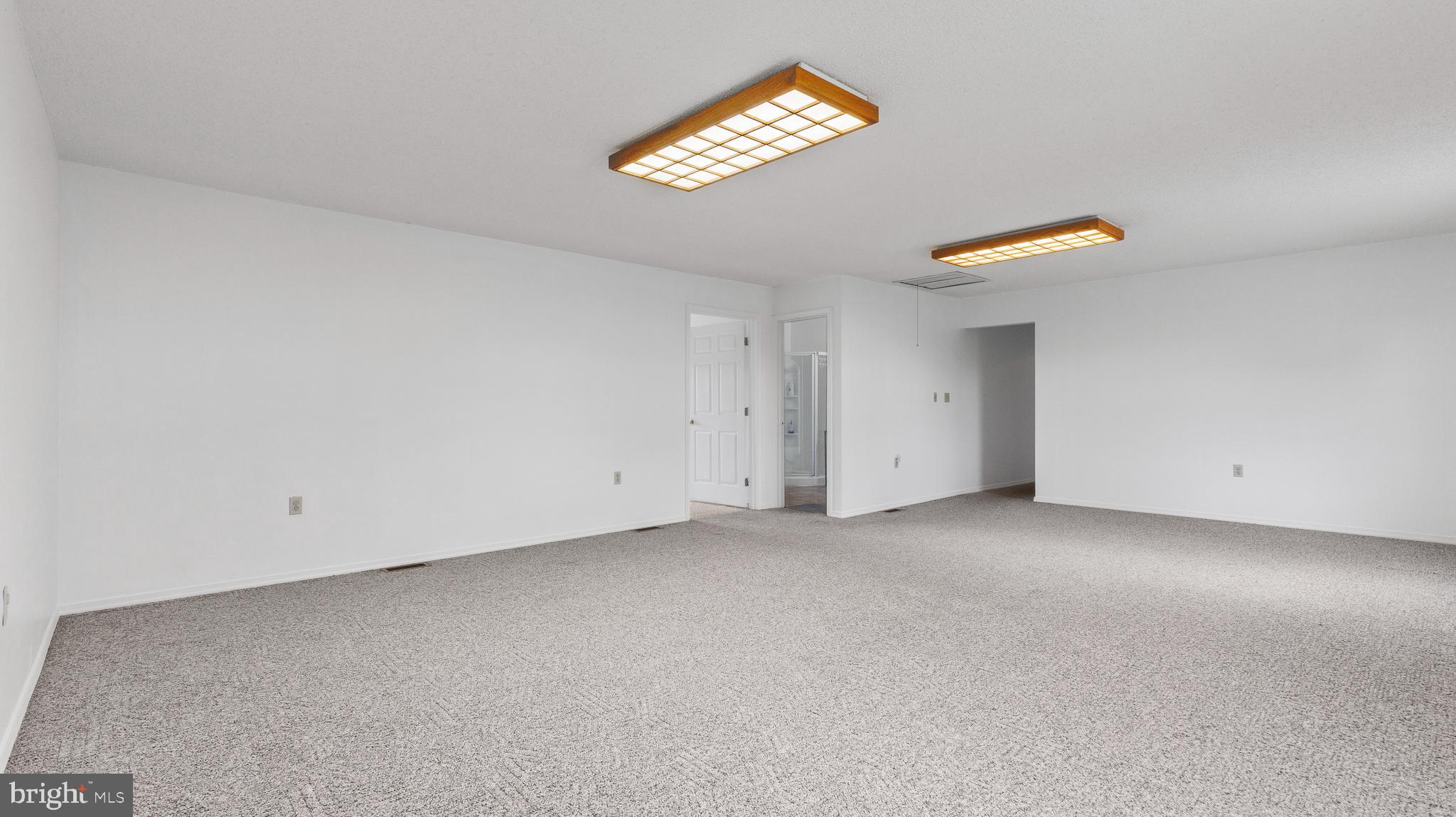 25 Powells Valley Road Halifax, PA 17032 - Photo 13 of 21 an empty room with a chandelier fan and windows