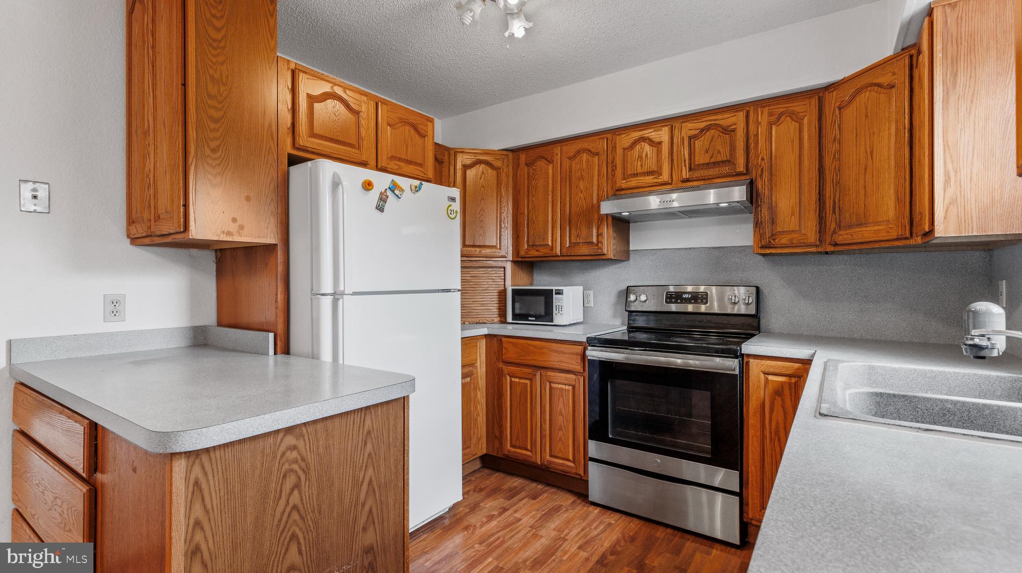 25 Powells Valley Road Halifax, PA 17032 - Photo 6 of 21 a kitchen with stainless steel appliances granite countertop a refrigerator a stove a sink and a microwave