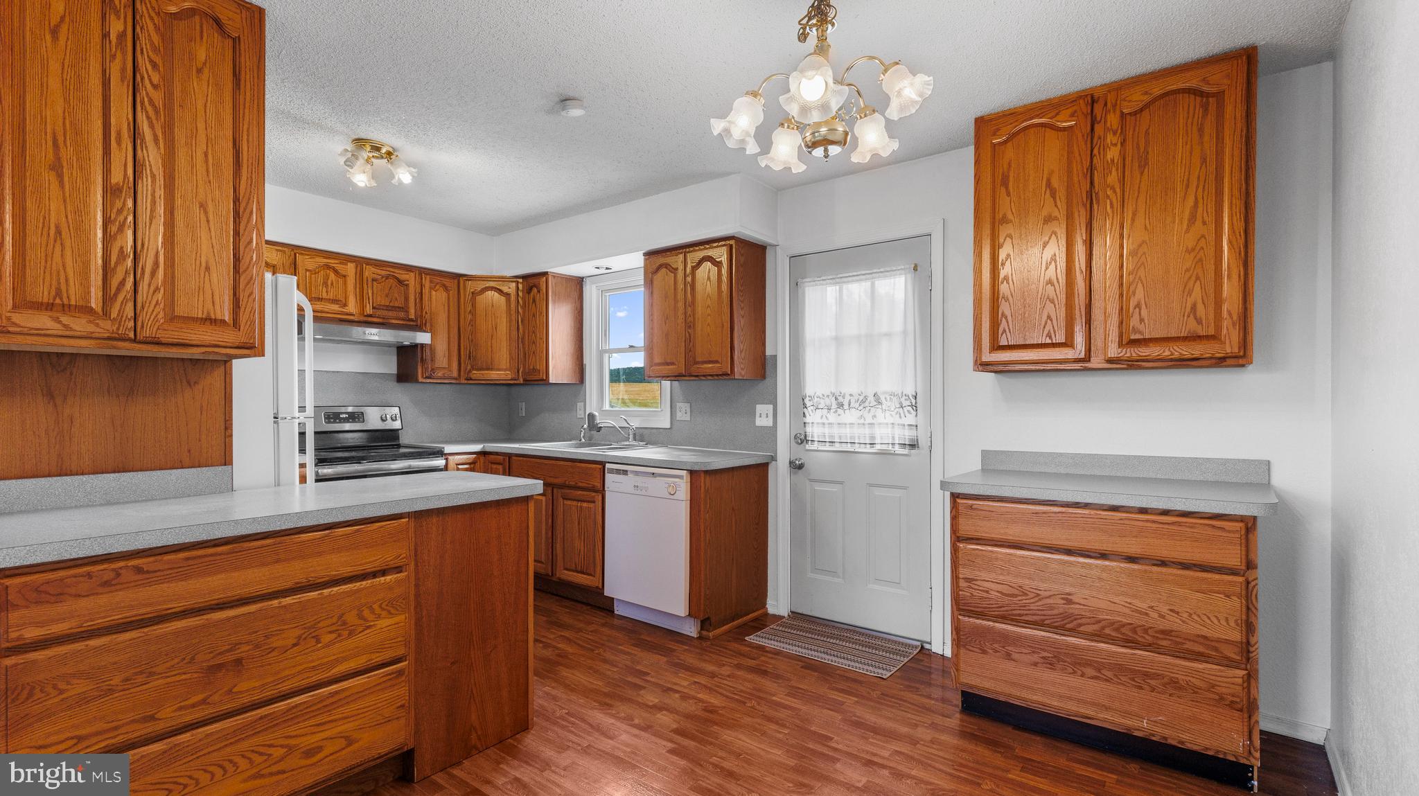 25 Powells Valley Road Halifax, PA 17032 - Photo 7 of 21 a kitchen with stainless steel appliances granite countertop wooden cabinets a stove a sink and dishwasher