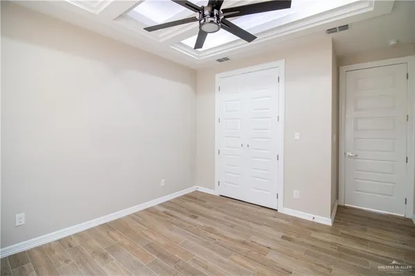 a view of entryway and hall with wooden floor