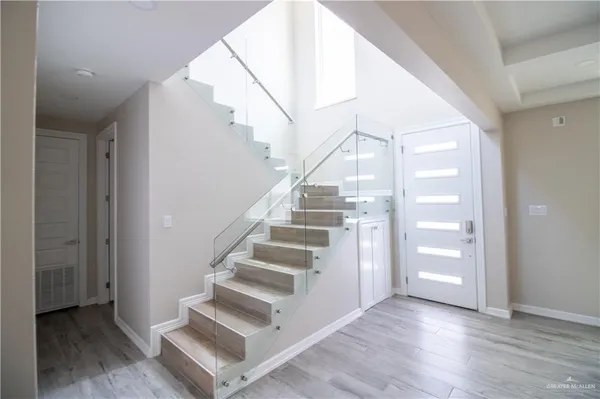 a view of walk in closet with wooden floor