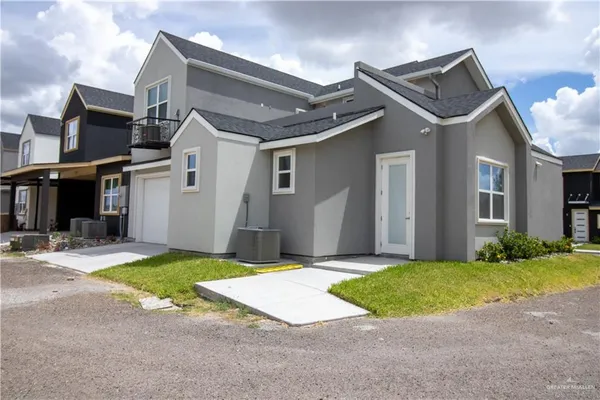 a view of a house with a yard and garage