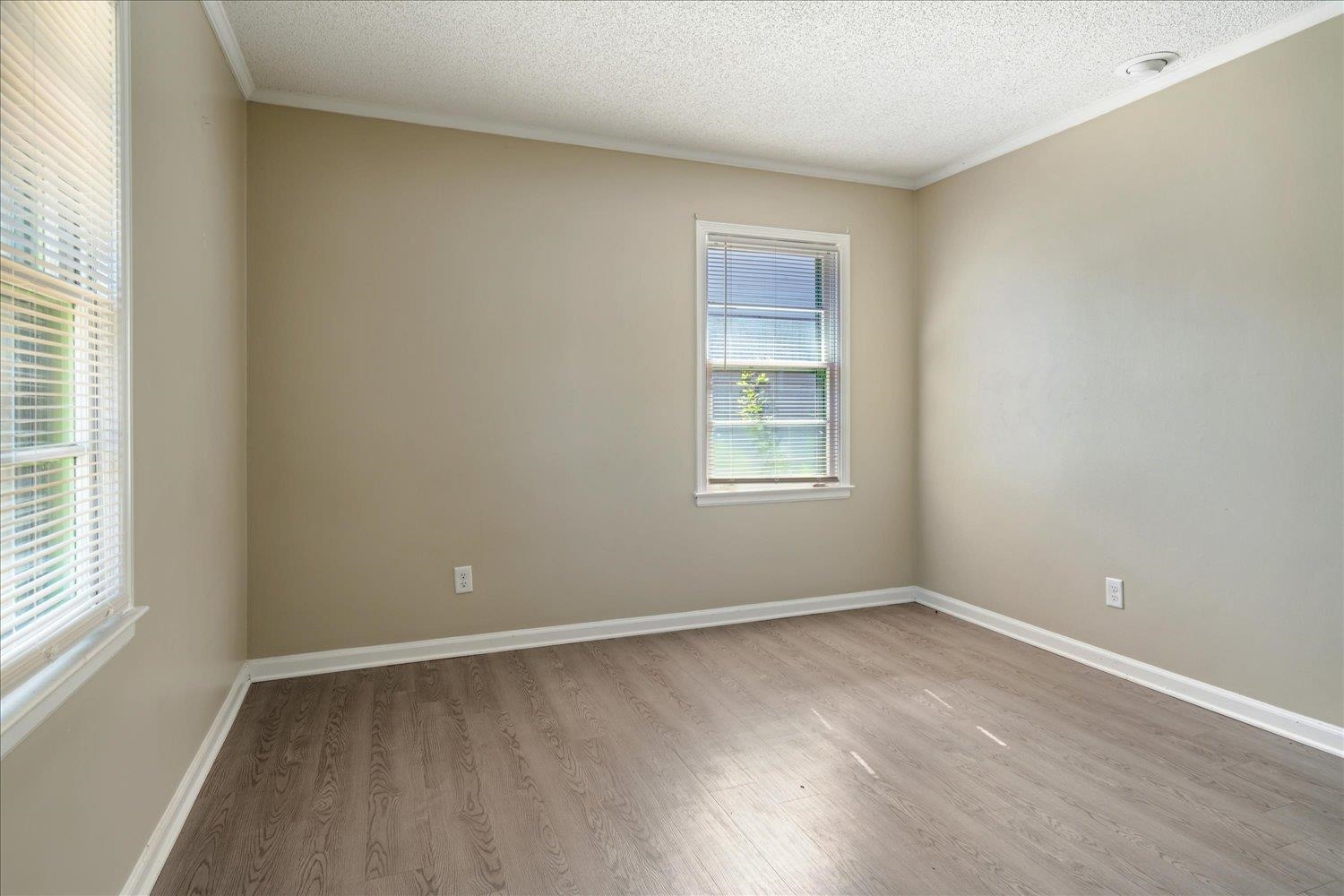 919 Stratford Road Memphis, TN 38122 - Photo 25 of 30 Spare room featuring ornamental molding, light hardwood / wood-style flooring, and a textured ceiling