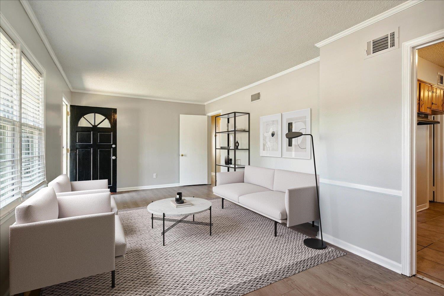 919 Stratford Road Memphis, TN 38122 - Photo 3 of 30 Living room featuring ornamental molding, hardwood / wood-style floors, and a textured ceiling
