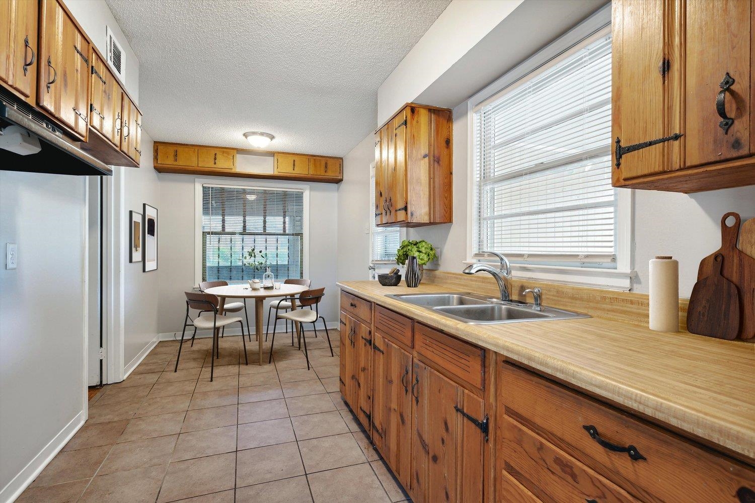 919 Stratford Road Memphis, TN 38122 - Photo 6 of 30 Kitchen featuring light tile patterned floors, a textured ceiling, and sink