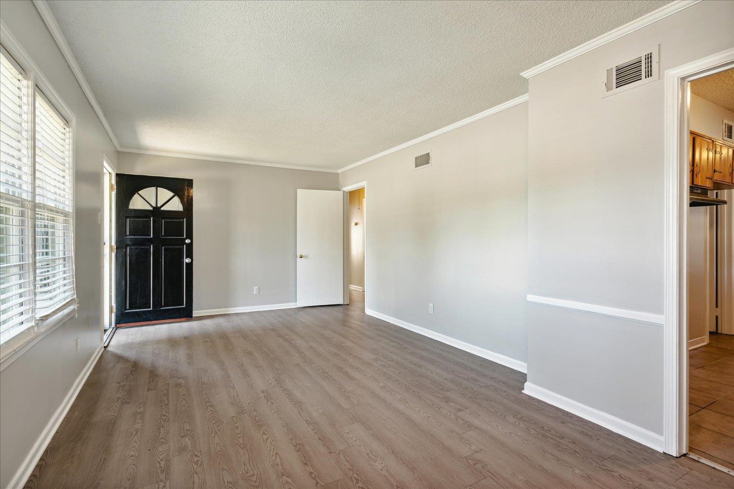 919 Stratford Road Memphis, TN 38122 - Photo 10 of 30 Entrance foyer featuring crown molding, hardwood / wood-style flooring, and a textured ceiling