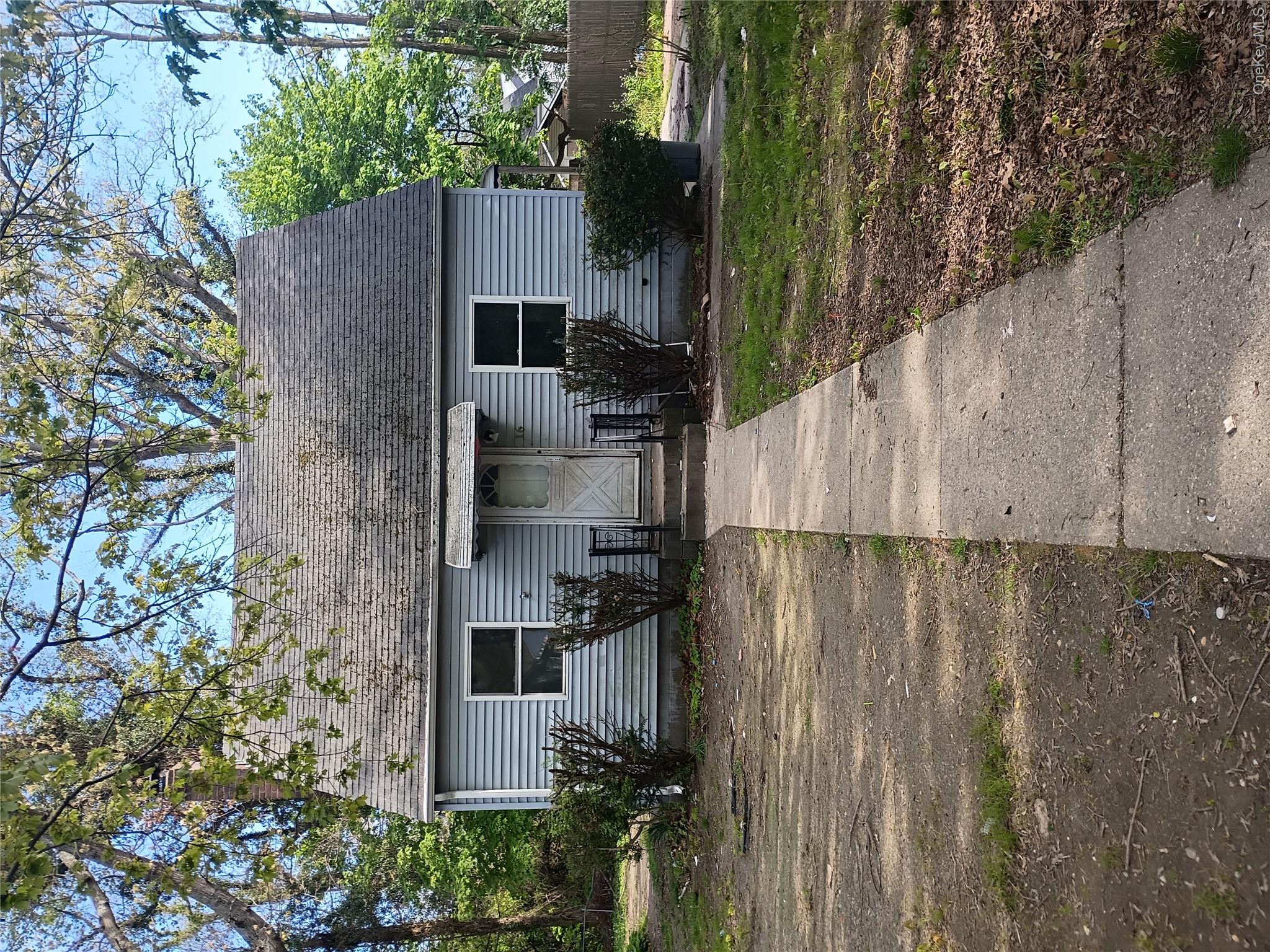 16 Neighborhood Road Mastic Beach, NY 11951 - Photo 1 of 4 a front view of a house with a yard and garage