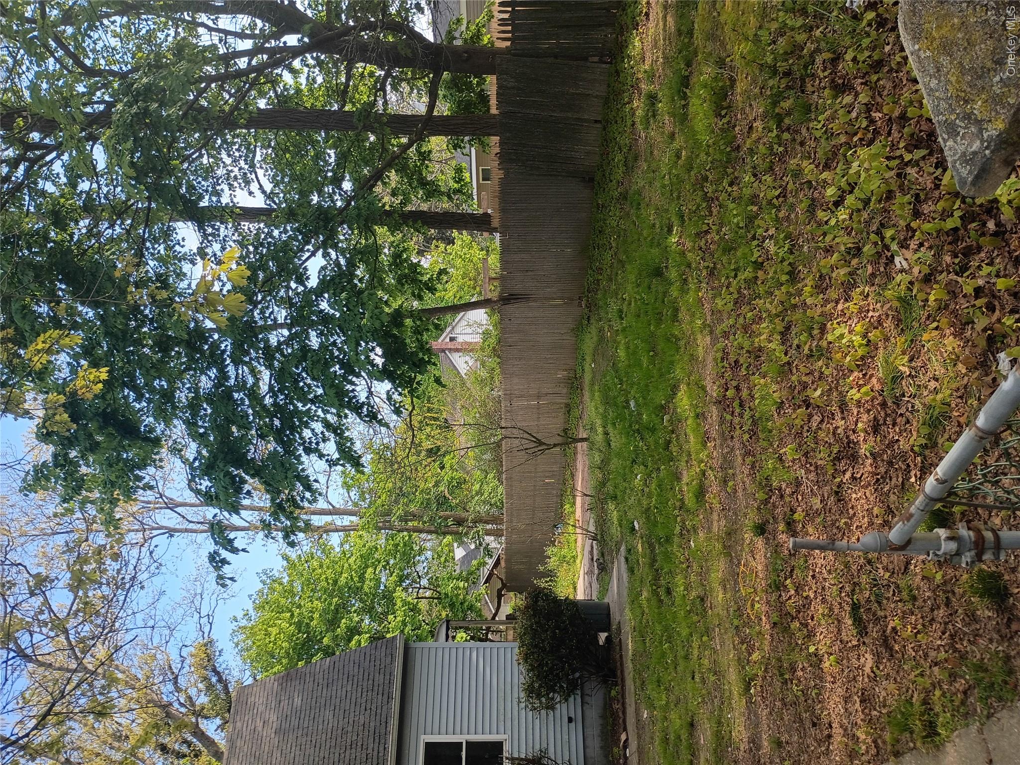 16 Neighborhood Road Mastic Beach, NY 11951 - Photo 2 of 4 a backyard of a house with lots of green space