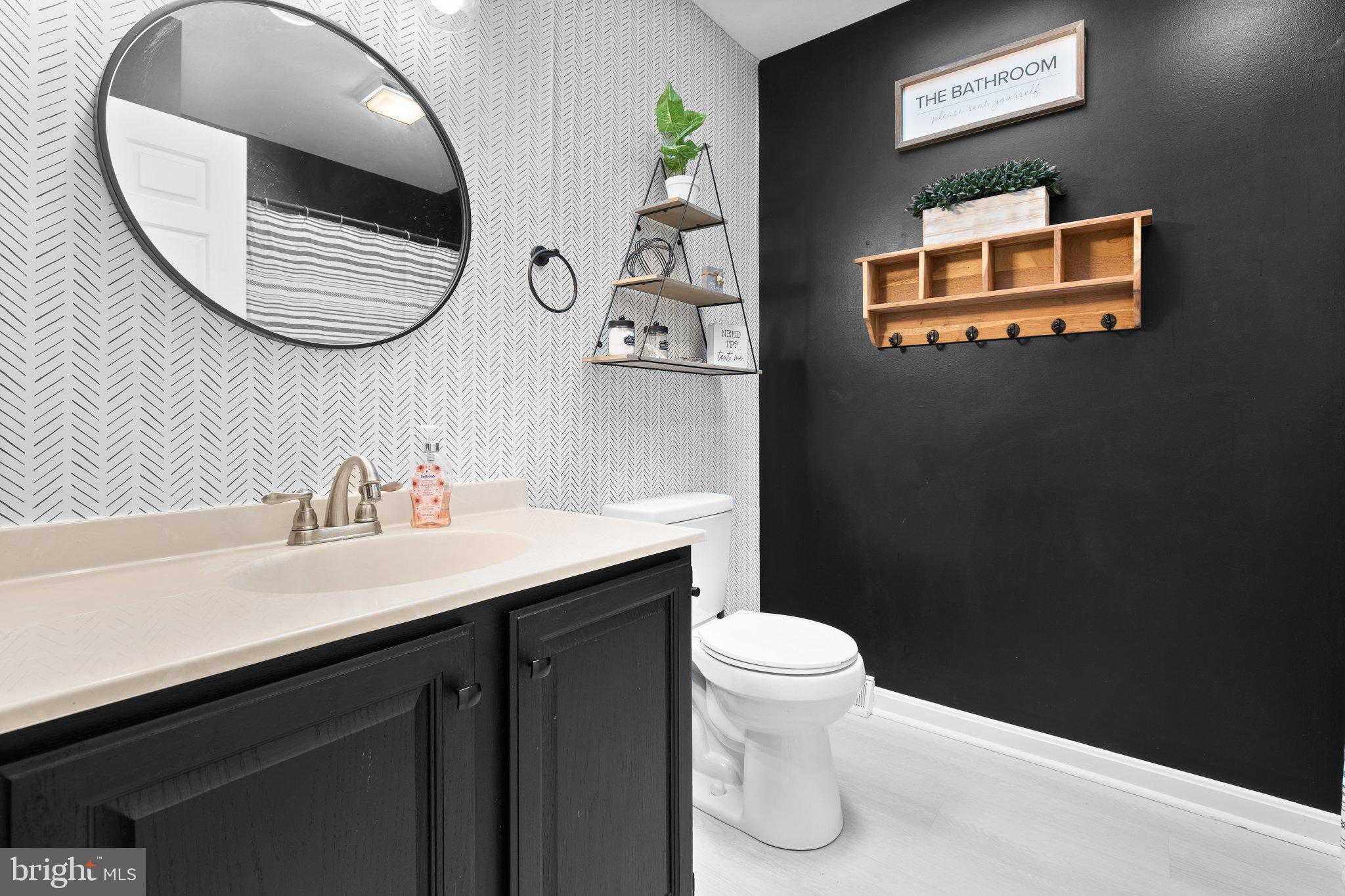 1024 Shadowstone Drive Lancaster, PA 17603 - Photo 17 of 28 a bathroom with a toilet a sink and mirror