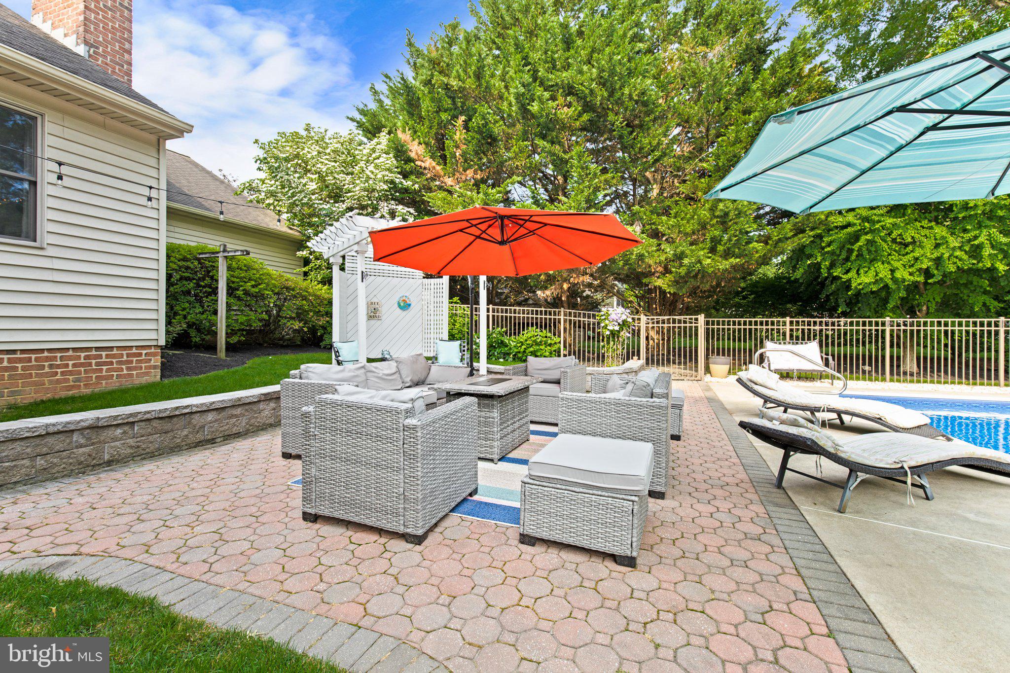 1024 Shadowstone Drive Lancaster, PA 17603 - Photo 23 of 28 a view of a patio with couches table and chairs under an umbrella