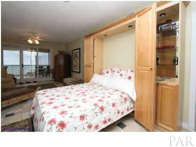 13599 Perdido Key Drive, Unit T12B Perdido Key, FL 32507 - Photo 6 of 12 a bedroom with a bed and a large mirror