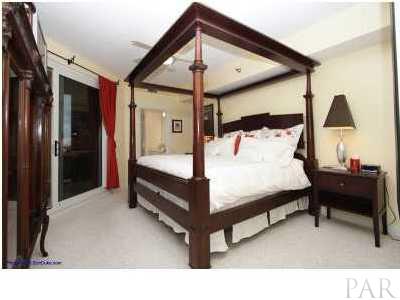 13599 Perdido Key Drive, Unit T12B Perdido Key, FL 32507 - Photo 7 of 12 a bedroom with a bed and a chandelier