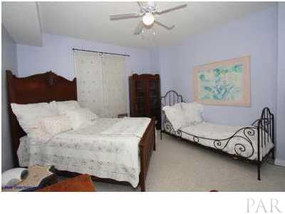 13599 Perdido Key Drive, Unit T12B Perdido Key, FL 32507 - Photo 8 of 12 a bedroom with a bed and ceiling fan