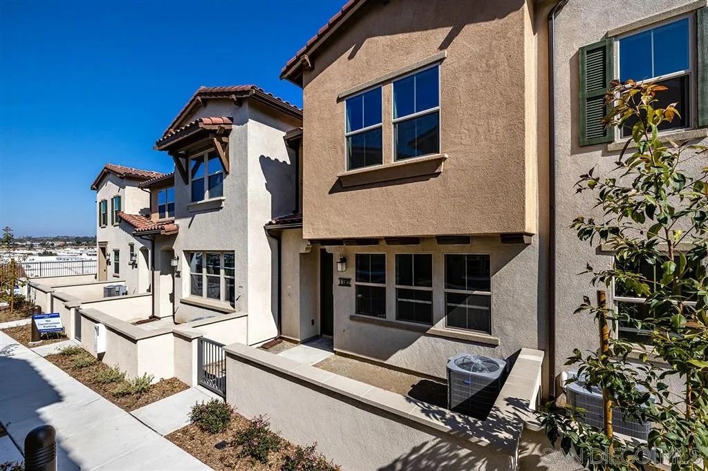 1182 Delpy View Point, Unit 106 Vista, CA 92084 - Photo 1 of 16 a view of a house with a large window and potted plants