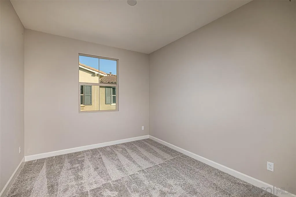 1182 Delpy View Point, Unit 106 Vista, CA 92084 - Photo 11 of 16 a view of an empty room with a window