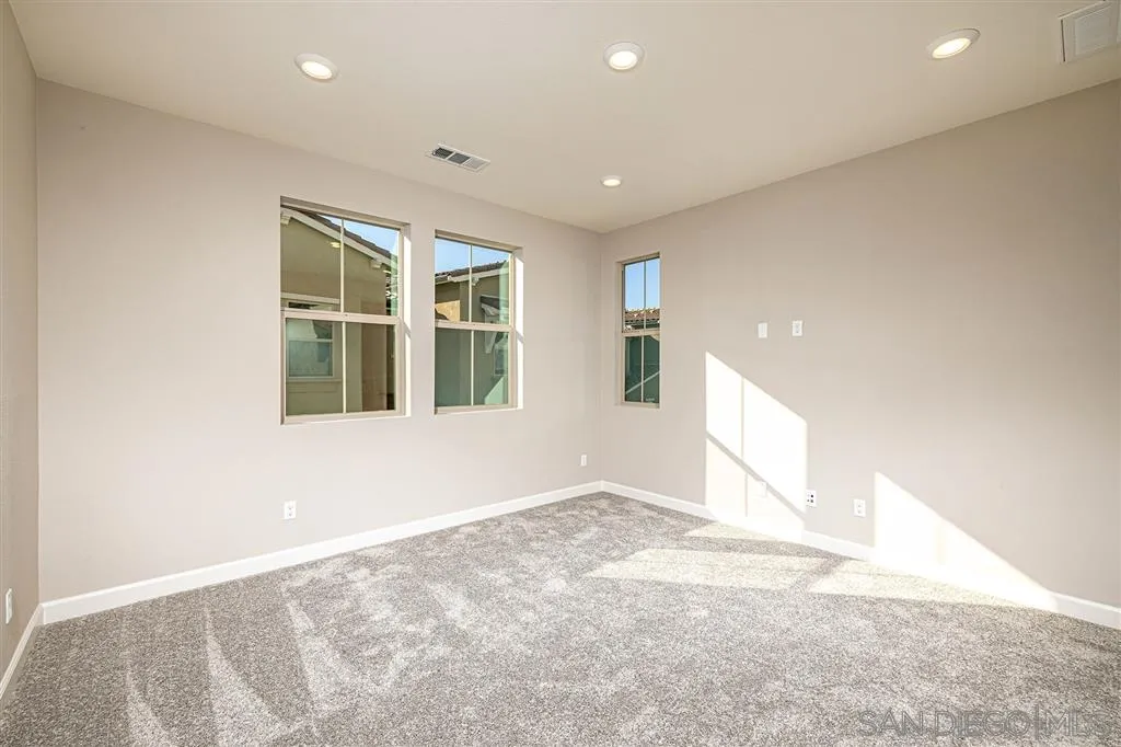 1182 Delpy View Point, Unit 106 Vista, CA 92084 - Photo 9 of 16 an empty room with windows