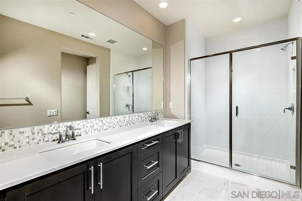 1182 Delpy View Point, Unit 106 Vista, CA 92084 - Photo 10 of 16 a bathroom with a double vanity sink mirror and double