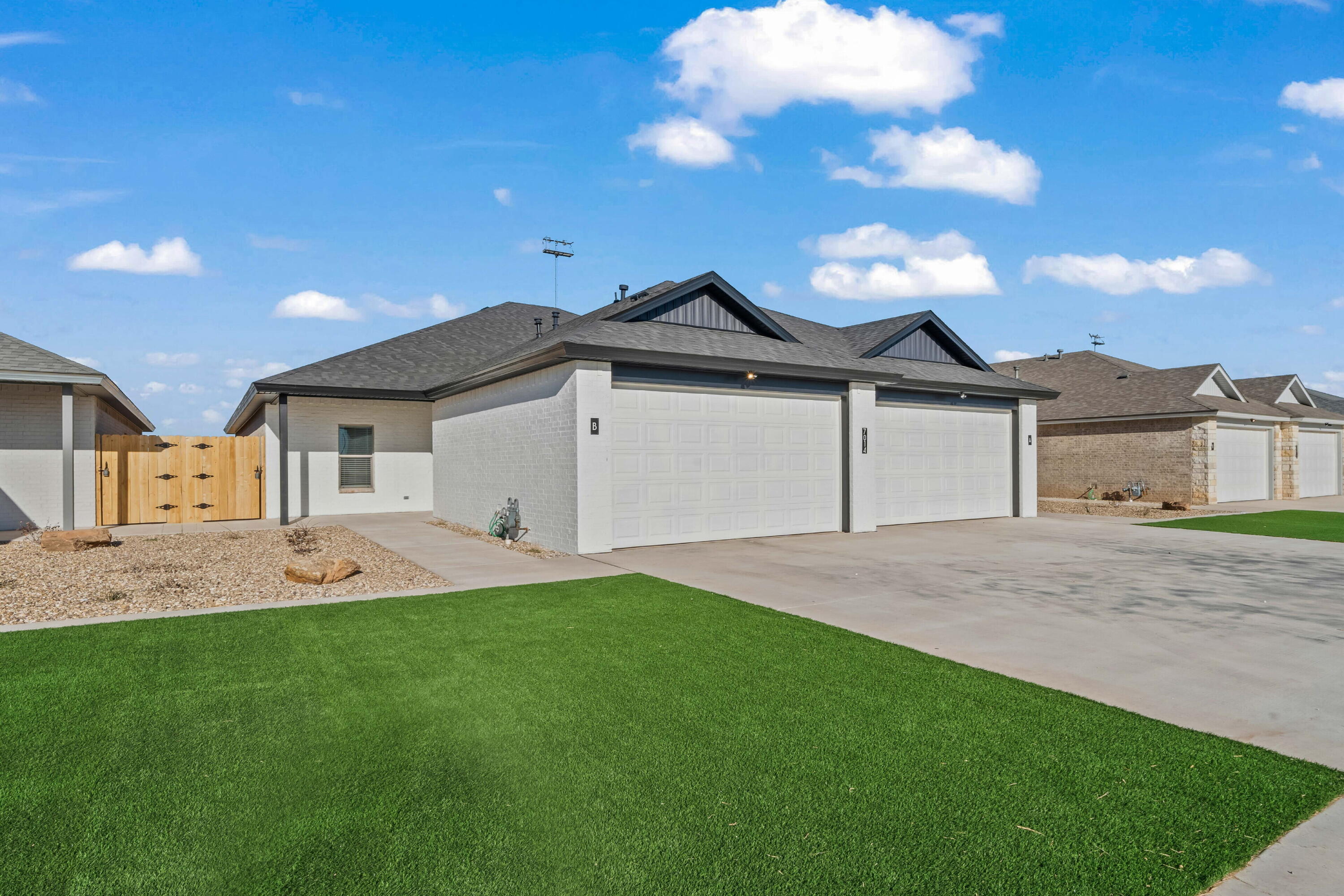 a front view of a house with a garden and yard