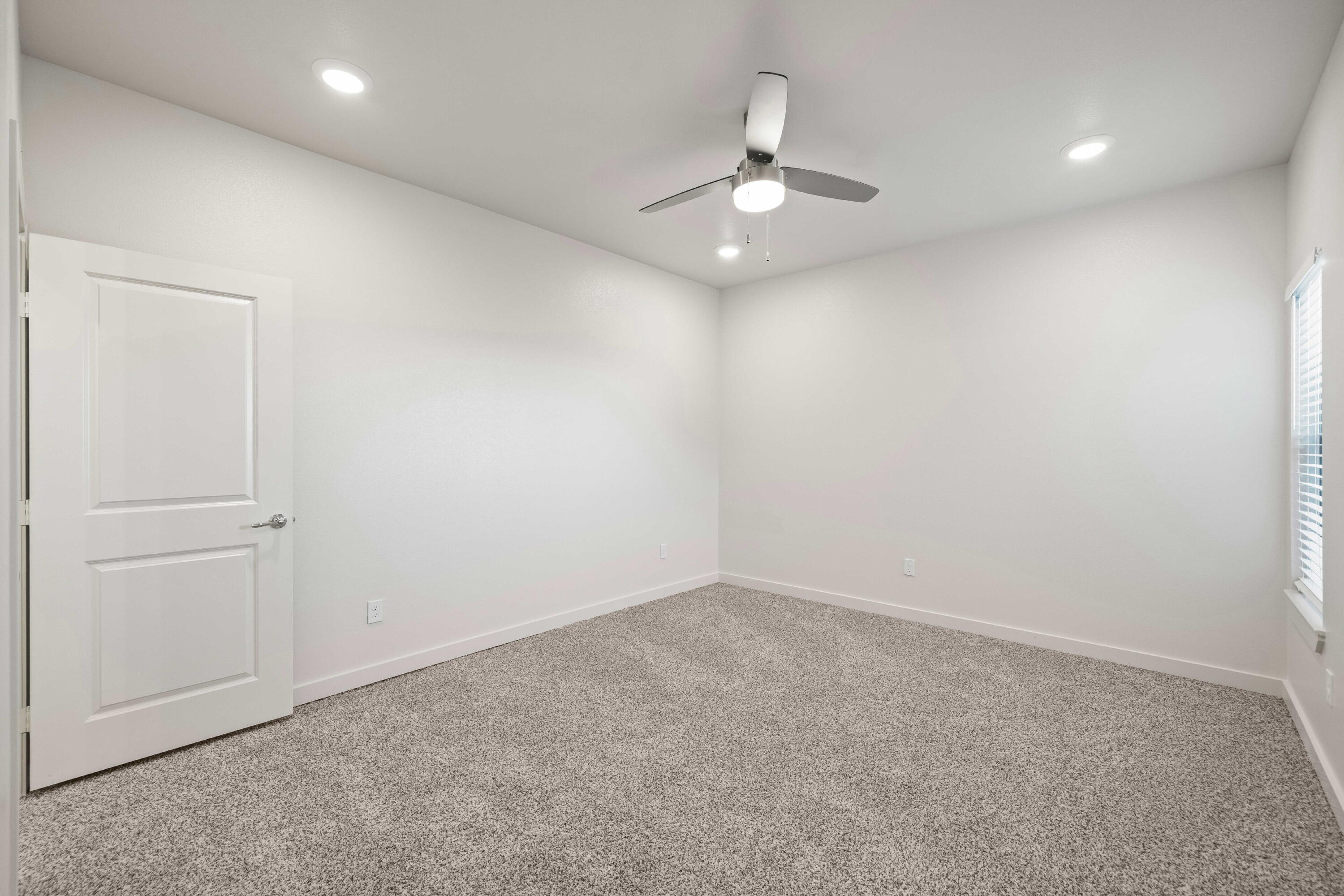 7014 40th Street, Unit B Lubbock, TX 79407 - Photo 12 of 20 an empty room with a chandelier fan