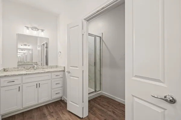 a bathroom with a granite countertop sink and a mirror