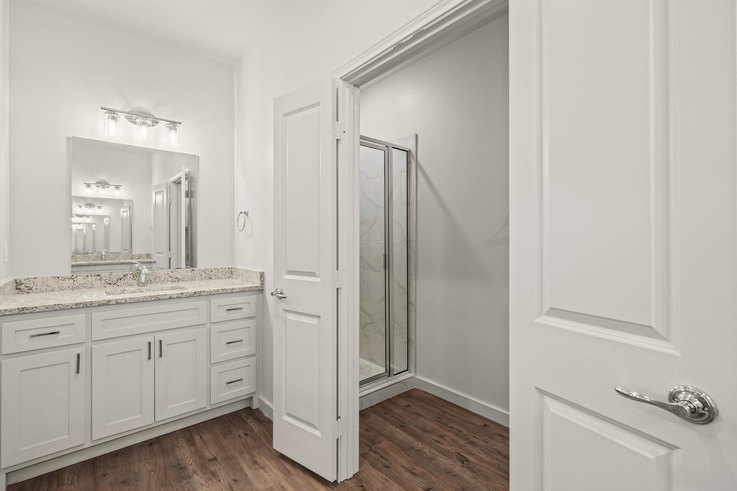 7014 40th Street, Unit B Lubbock, TX 79407 - Photo 15 of 20 a bathroom with a granite countertop sink and a mirror