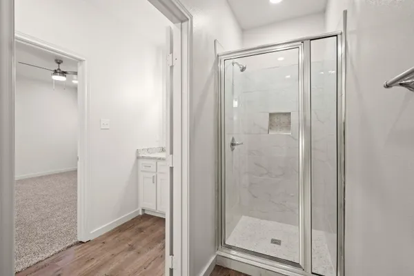 a bathroom with a glass shower door