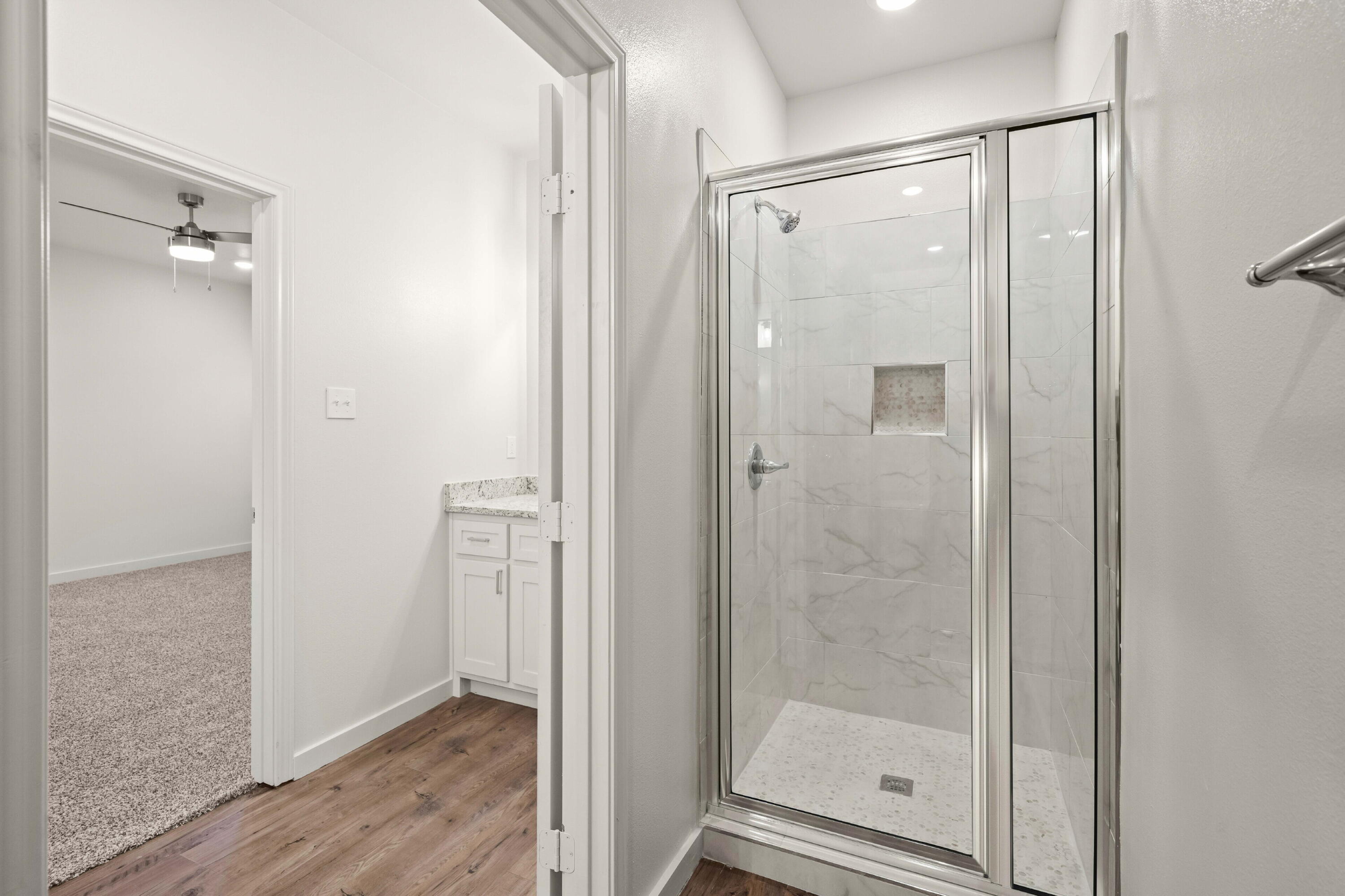 7014 40th Street, Unit B Lubbock, TX 79407 - Photo 16 of 20 a bathroom with a glass shower door