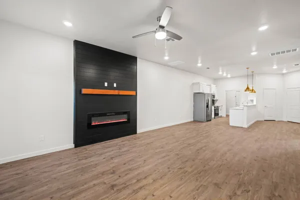 a view of an empty room with a kitchen