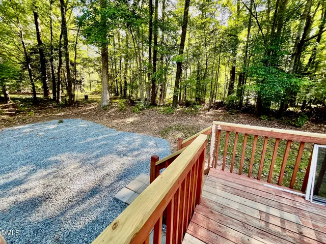 a view of deck with wooden floor and trees